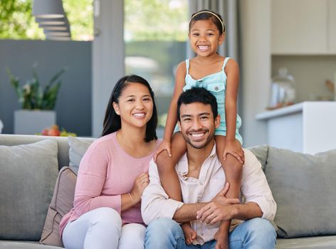 My family are my world. a young family relaxing together at home