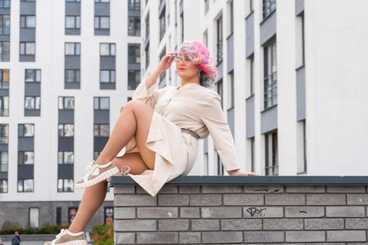 Portrait of a middle-aged woman with multi-colored hair walks on the streets of the city