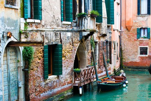 Old buildings and gondola on canal in Venice