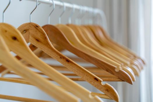 Close-up of wardrobe with wooden clothes hanger