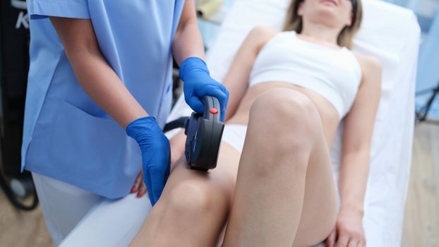 Laser hair removal on beautiful female legs in beauty clinic. Long term body hair removal concept