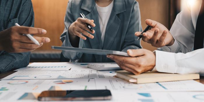 Business team meeting and discussing project plan. Businessmen discussing together in meeting room. Professional investor working with business project together