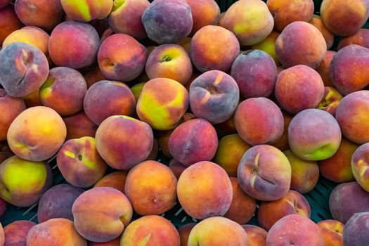 Peaches closeup background. A group of ripe peaches on the counter in a supermarket.