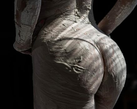 Female naked butt covered with plaster like a statue