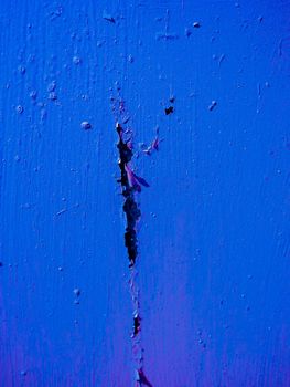 Texture of old blue damaged paint on the wall.