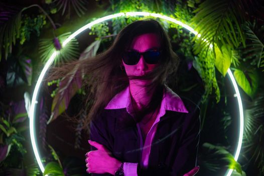 Portrait of asian man wearing sunglasses in neon light