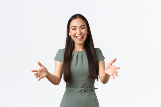 Small business owners, women entrepreneurs concept. Happy attractive asian businesswoman, company CEO reaching hands forward and smiling friendly as inviting investors, greeting clients.