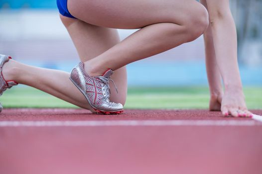 Close-up of female legs. The runner in the stadium is ready for the race