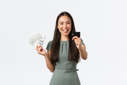 Small business owners, women entrepreneurs concept. Smiling businesswoman recommend using credit card instead of cash during coronavirus pandemic, standing white background.