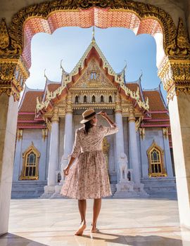 Wat Benchamabophit temple in Bangkok Thailand, The Marble temple in Bangkok. Asian woman with hat visiting temple in Bangkok