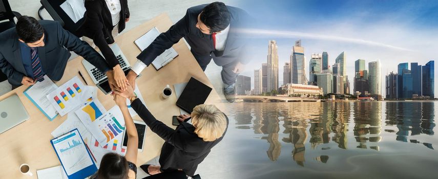 Happy business people celebrate teamwork success in widen view together with joy at office table shot from top view . Young businessman and businesswoman workers express cheerful victory .