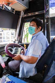 Bangkok Thailand July 2022 people with mas in a red bus public transport during covid 19 pandemic. people using public transport with face mask