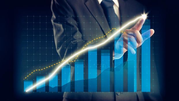 Businessman draw finance allusive graph chart showing business profit growth increasing to future target . Excellent financial status of corporate business rise up . Finance and money technology .