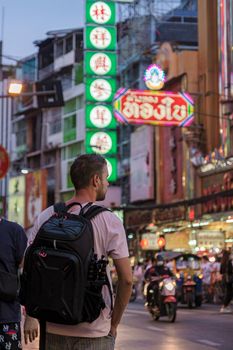 China town Bangkok Thailand, colorful streets of China Town Bangkok.European men with bag, tourist visiting Chinatown