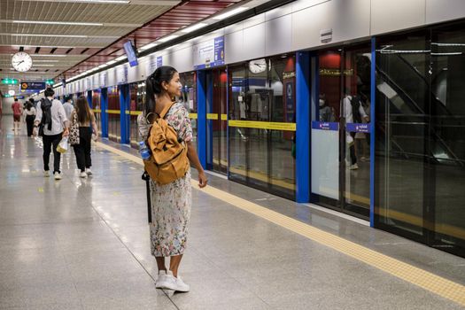 Bangkok Thailand, Portrait of Beautiful Asian woman tourist waiting for Skytrain at the railway station platform in the city. Confidence females enjoy city life lifestyle travel and shopping