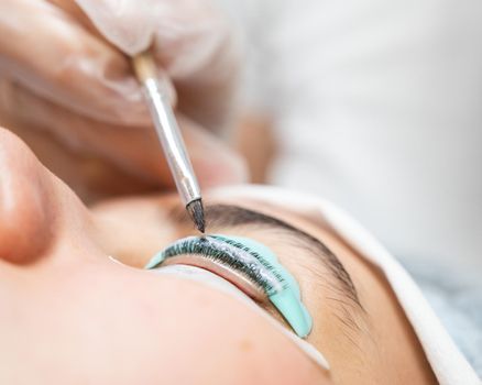 Close-up portrait of a woman on eyelash lamination procedure