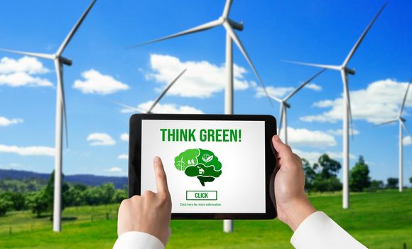 Green business transformation for environment saving and ESG business concept. Businessman using tablet to set corporate goal toward environmental friendly management and alternative clean energy use.