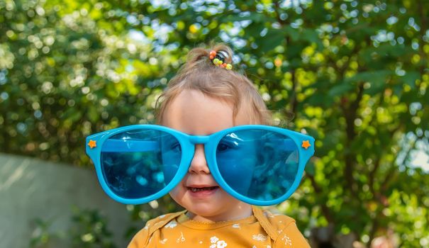 Children enjoy nature in glasses. Selective focus. Nature.