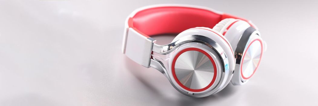 White red wireless headphones on gray background. Choosing headphones for listening to music concept