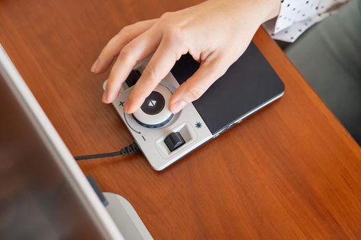 A woman uses a special magnification device for the visually impaired