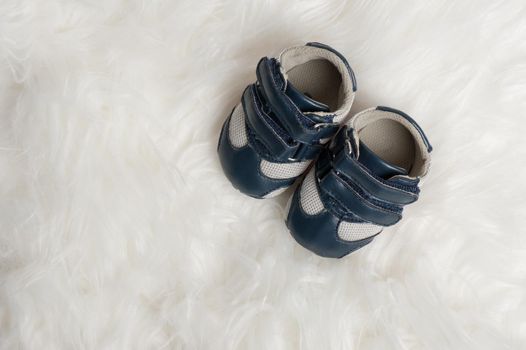 closeup little blue shoes for baby over white background