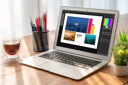 Graphic designer software for modern design of web page and commercial ads showing on the computer screen