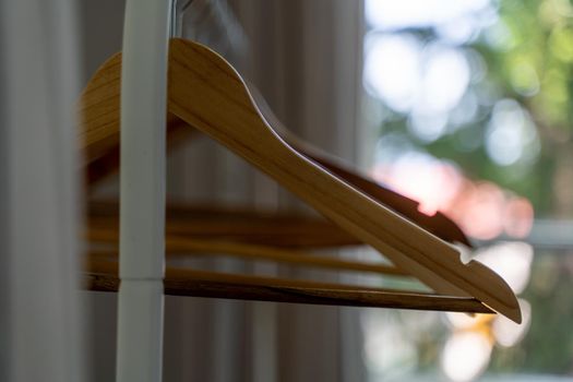 Close-up of wardrobe with wooden clothes hanger