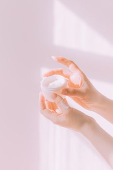 Women's hands hold a cosmetic copy space cream . An article about care cosmetics. Hand cream. Face cream.