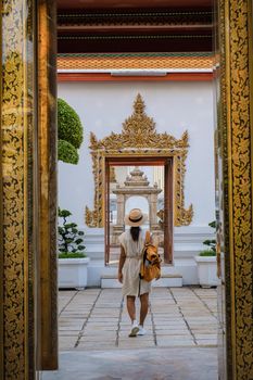 Wat Pho temple in Bangkok Thailand, The reclining temple in Bangkok. Beautiful Buddhist temple on a bright sunny day. Asian woman visiting Wat Pho temple