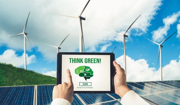 Green business transformation for environment saving and ESG business concept. Businessman using tablet to set corporate goal toward environmental friendly management and alternative clean energy use.