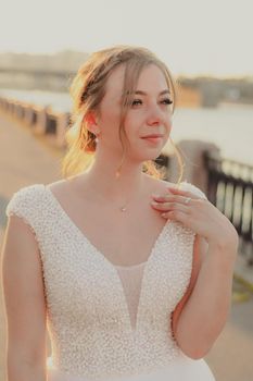 Portrait of the bride in the evening light . Wedding article. Wedding season. Choosing a wedding dress. Make-up and hairstyle for the holiday. Happy bride.