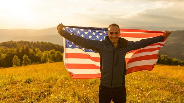 man holding an american flag.