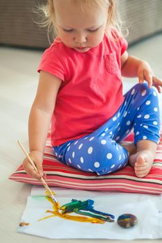 toddler paints with gouache. High quality photo