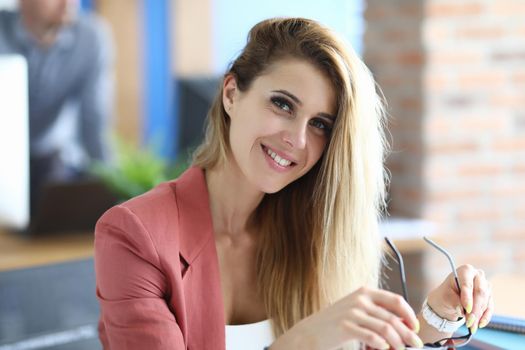 Portrait of beautiful smiling businesswoman in workplace. Successful career in women in business concept