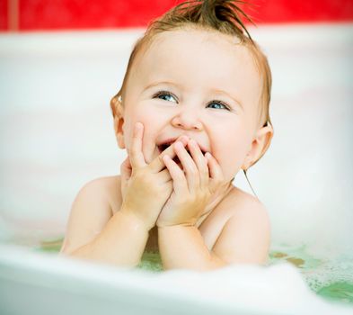 face of a smiling little baby in the bathroom