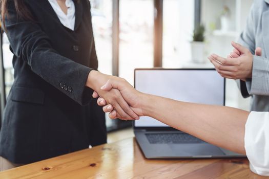 business merger, Asian businessman shake hands at the conference room with showcase their collaboration to strengthen their marketing efforts.