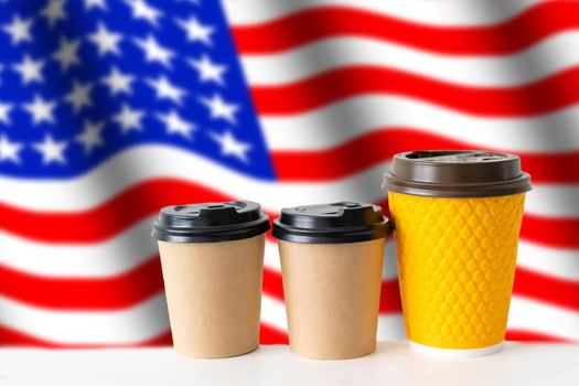 Closeup of American flag with coffee paper cups