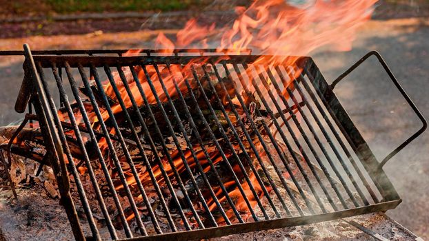 Detail of grill grid on fire. Fireball igniting on grill