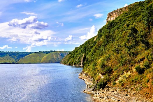 a large natural stream of water flowing in a channel to the sea, a lake, or another such stream.