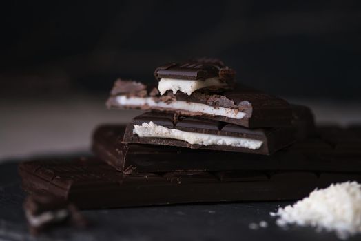 chocolate homemade bars with coconut fillings. dark food photo
