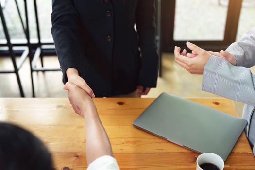 business merger, Asian businessman shake hands at the conference room with showcase their collaboration to strengthen their marketing efforts.