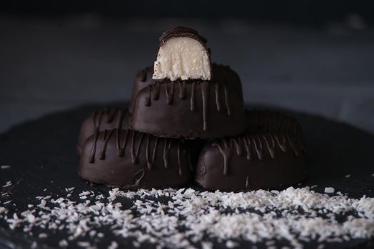 chocolate homemade bounty with coconut fillings.dark food photo