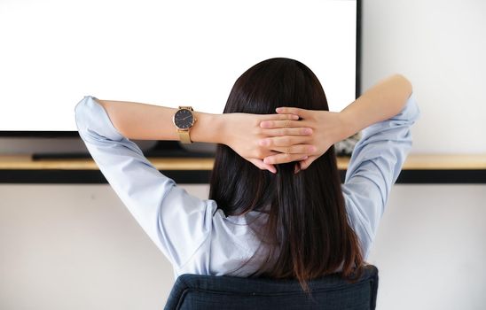 a young woman resting to watch television during the weekend, the white space on the TV can be inserted into text or images