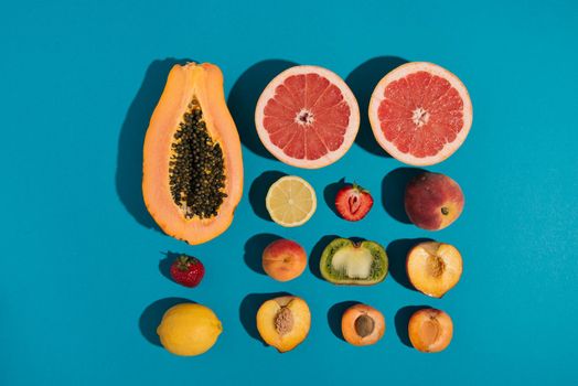 tropical summer fruits on blue background. creative arrangement