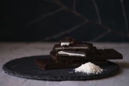 chocolate homemade bars with coconut fillings. dark food photo