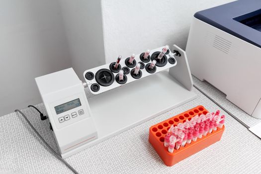 Raw of laboratory samples next to a centrifuge reaction vessel in a hospital room