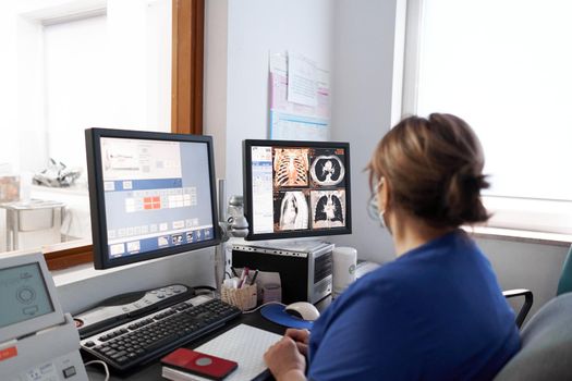 Female doctor examining images from a tomography in an hospital