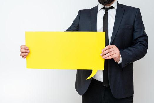 Businessman Holding Speech Bubble With Important Informations.