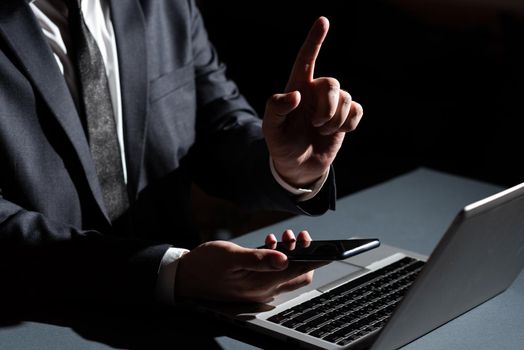 Man Holding Mobile Phone In Hand And Pointing With One Finger On Data.