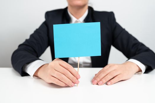 Businesswoman Presenting Important Message On Paper Attached To Stick.